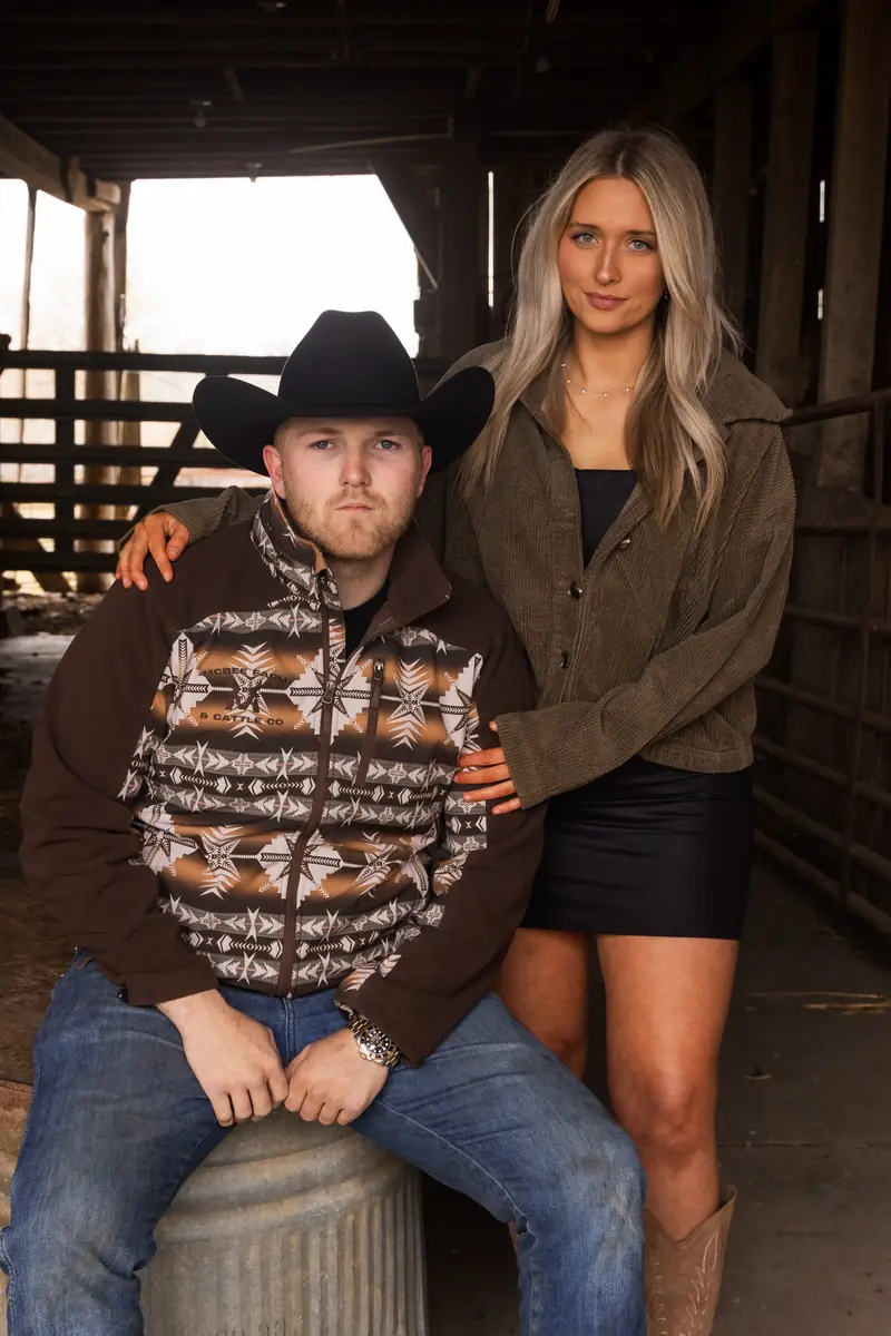 Kacie standing beside Cole McBee in the barn